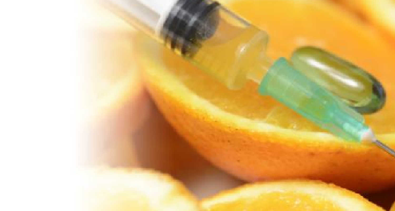 Syringe with B12 laying on orange peels