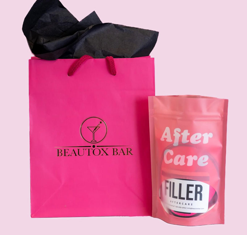 pink gift bag with filler after care pouch
